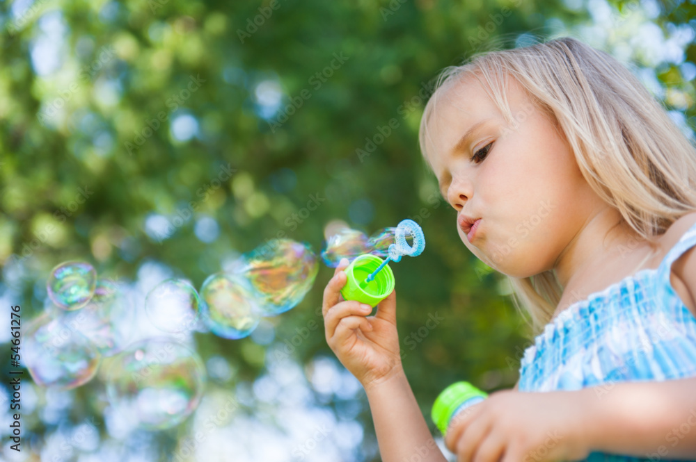 little girl with soap bubbles