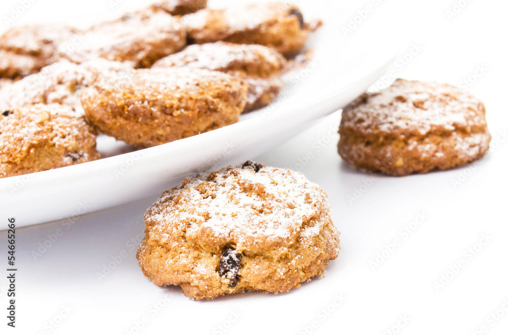 Pile of chocolate chip cookies on a dish on white background