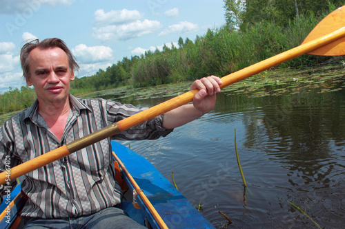 A man swims in a kayak