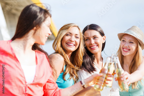 girls with drinks on the beach
