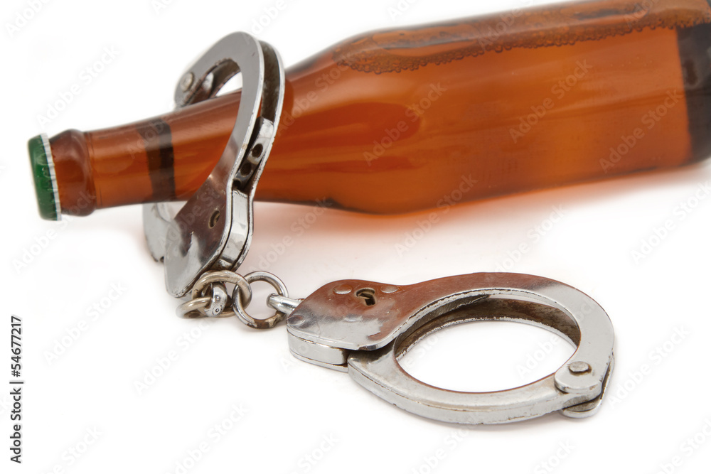 Obraz premium bottle beer and handcuffs,Drunk driving concept