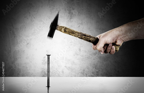 Картината върху платно Hand with hammer nailing