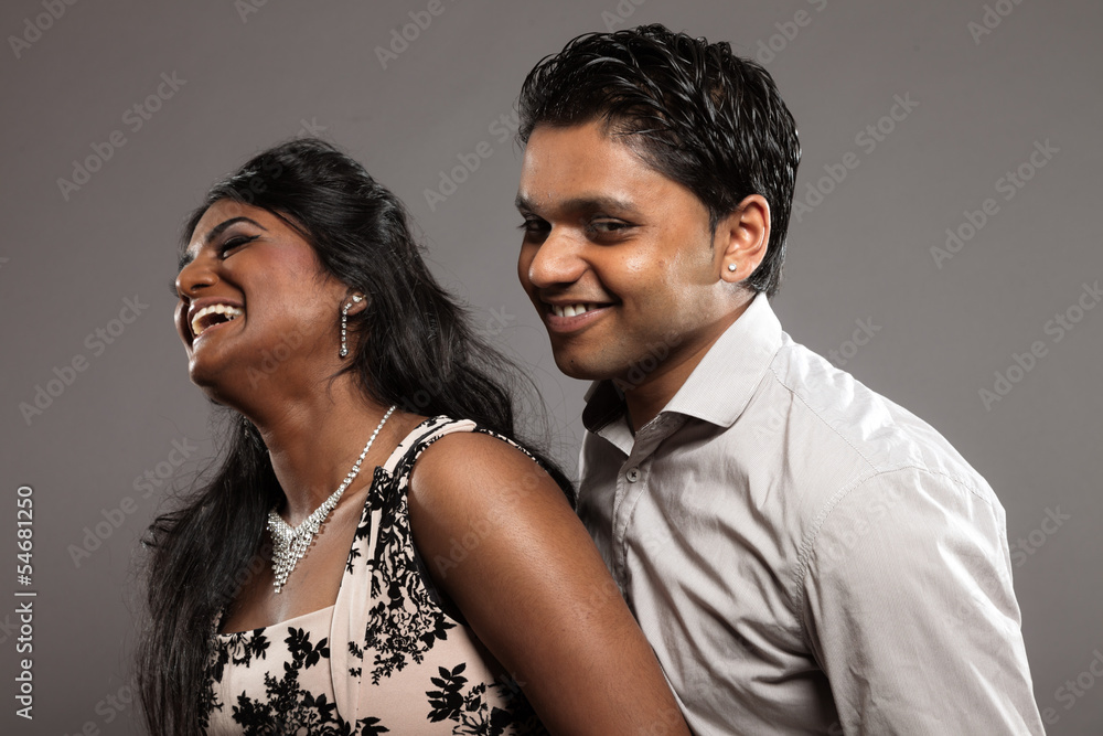 Fashionable passionate indian couple. Studio shot against grey. Fashionable passionate indian couple. Studio shot against grey.