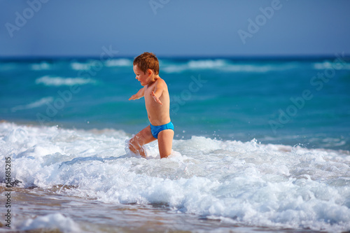 happy boy kid having fun in sea water © Olesia Bilkei