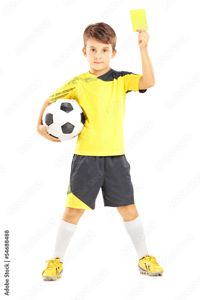 Kid in sportswear holding soccer ball and giving yellow card