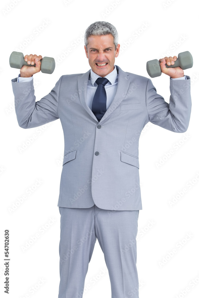 Strong businessman lifting dumbbells Strong businessman lifting dumbbells
