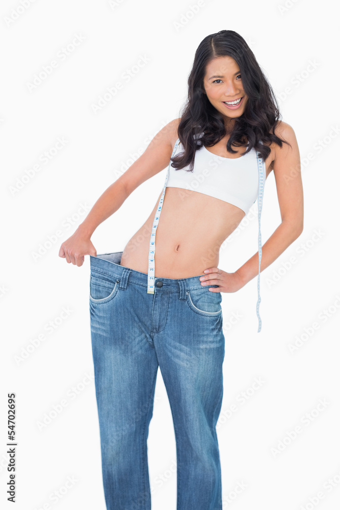 Smiling sexy woman wearing too big pants Smiling sexy woman wearing too big pants