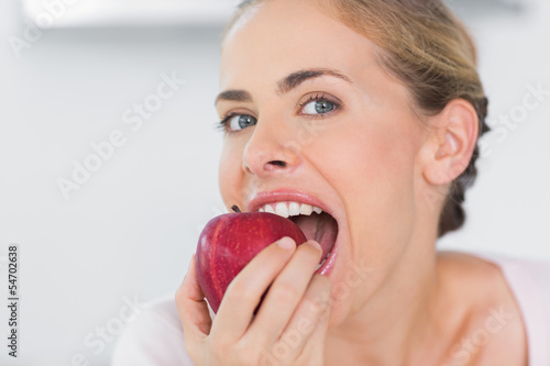 Attractive woman munching apple
