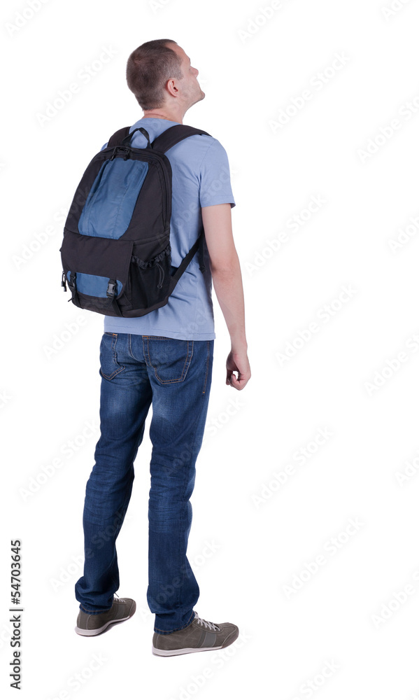 Back view of man with backpack looking up. Back view of man with backpack looking up.