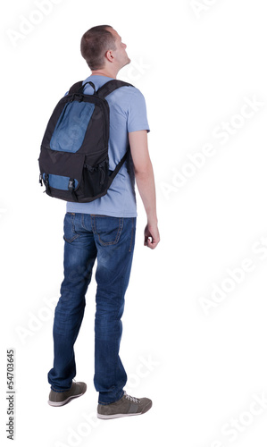 Back view of man with  backpack looking up.