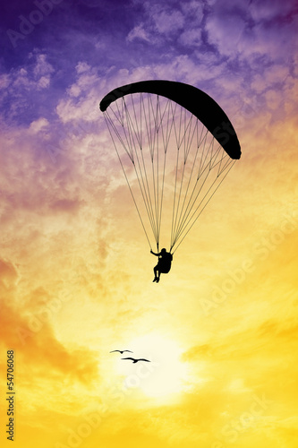 Paragliding silhouette at sunset
