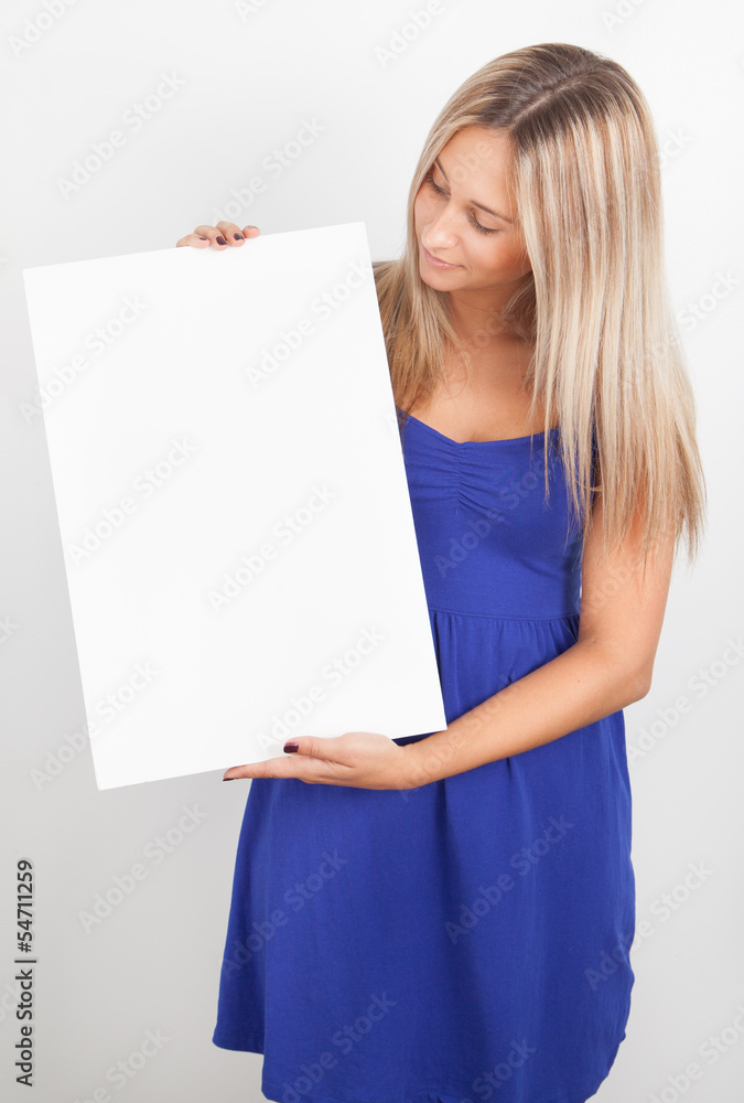Portrait of a young woman holding a blank billboard Portrait of a young woman holding a blank billboard