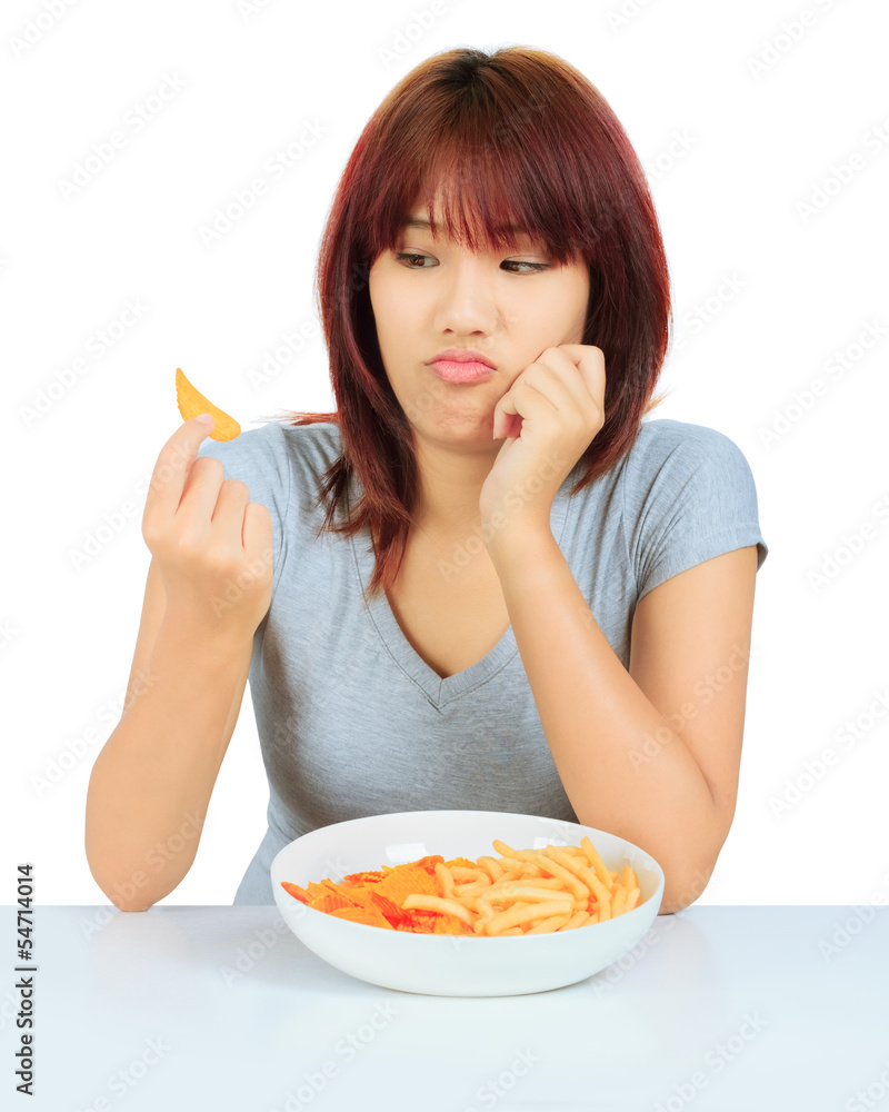 Isolated young asian woman with a plate of potato chips and fren Isolated young asian woman with a plate of potato chips and fren