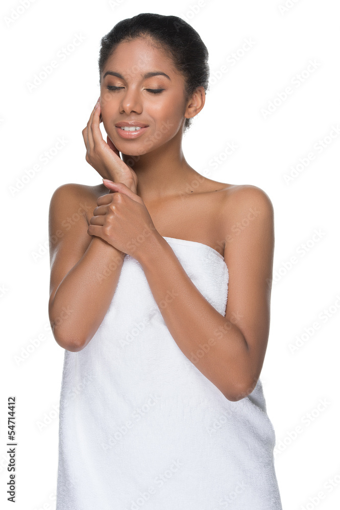 Touching her smooth skin. Beautiful young women wrapped in towel Touching her smooth skin. Beautiful young women wrapped in towel