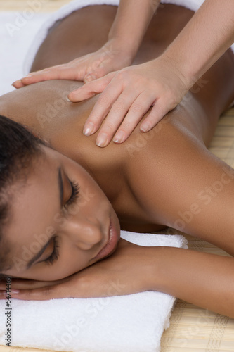 Enjoying massage. Beautiful young women enjoying massage while l