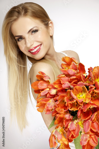 Fototapeta Naklejka Na Ścianę i Meble -  Beautiful blonde girl with the bouquet of tulips isolated on a w