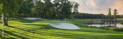 Panoramic view of golf green with white sand traps