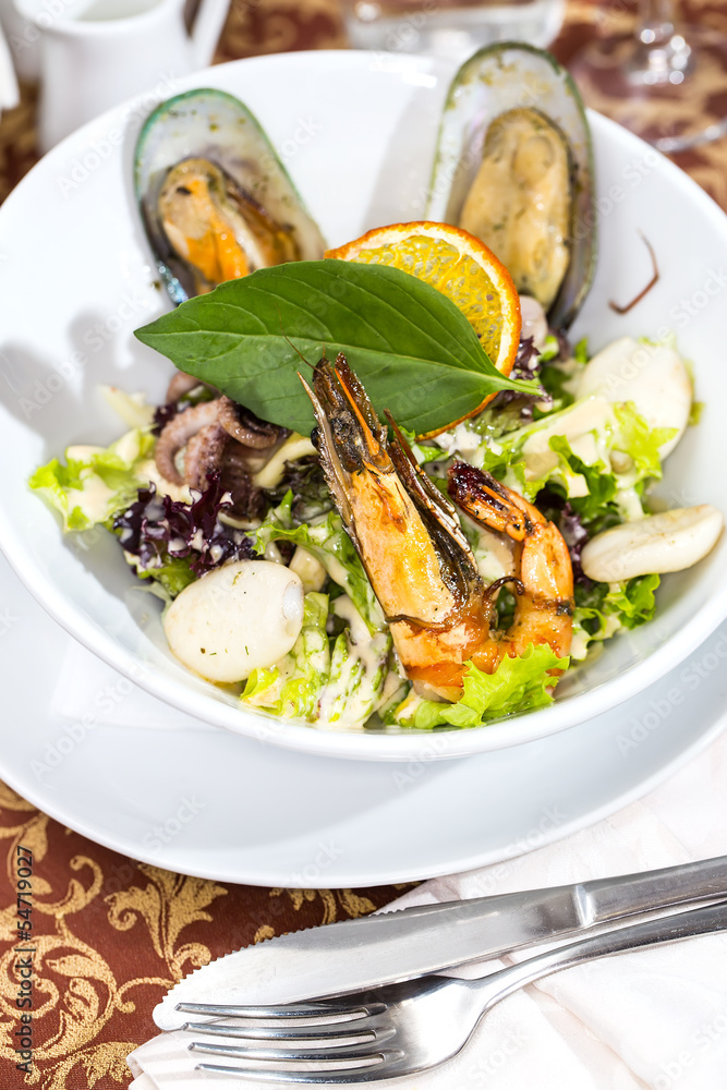 salad with vegetables and seafood on the table in a restaurant