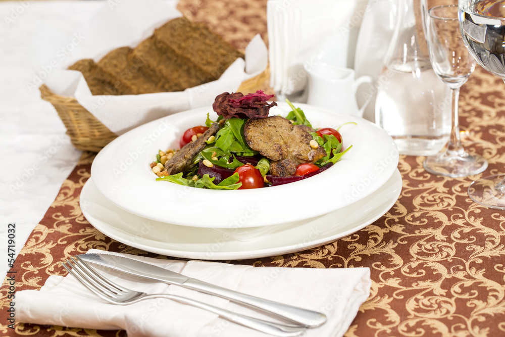 rabbit liver salad with arugula in a restaurant rabbit liver salad with arugula in a restaurant