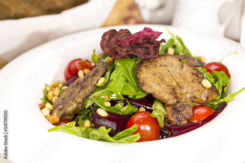 rabbit liver salad with arugula in a restaurant