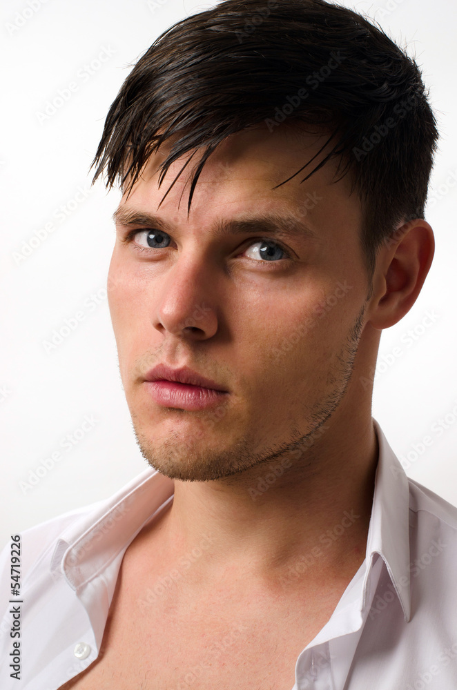 Portrait of a beautiful man posing fashion in a studio Portrait of a beautiful man posing fashion in a studio