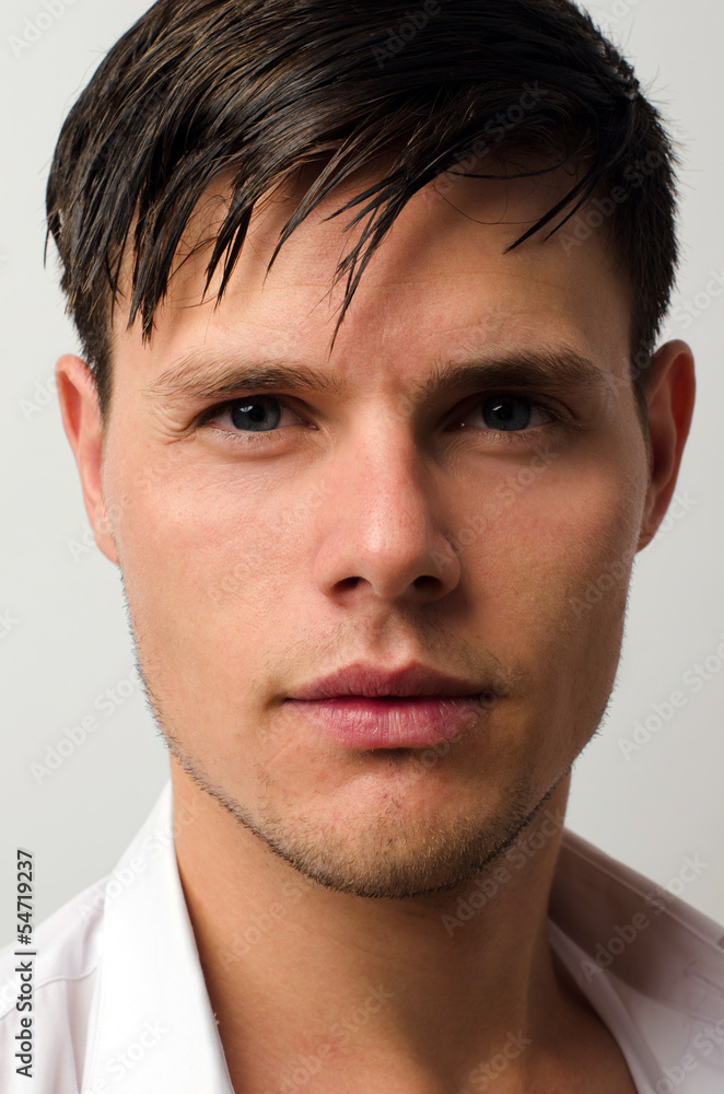 Fototapeta premium Portrait of a beautiful man posing fashion in a studio