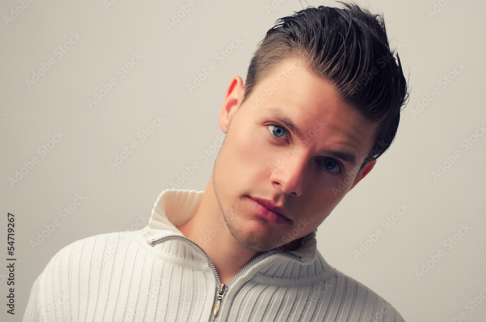 Fototapeta premium Portrait of a beautiful man posing fashion in a studio