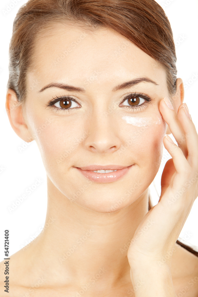 beautiful brunette young woman using facial creme