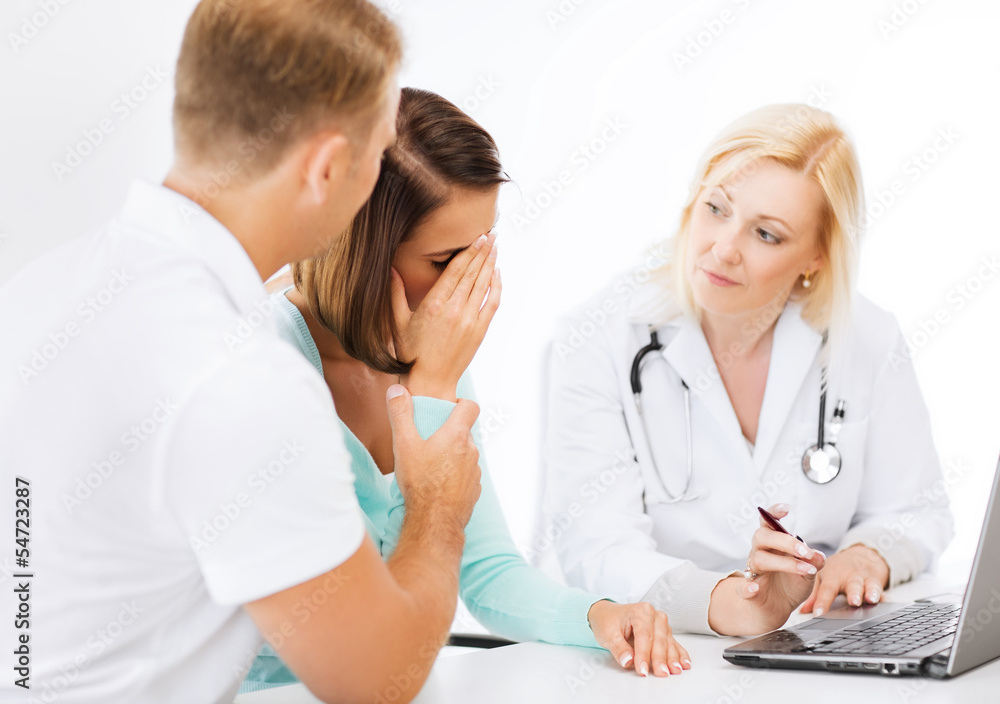 doctor with patients looking at laptop doctor with patients looking at laptop