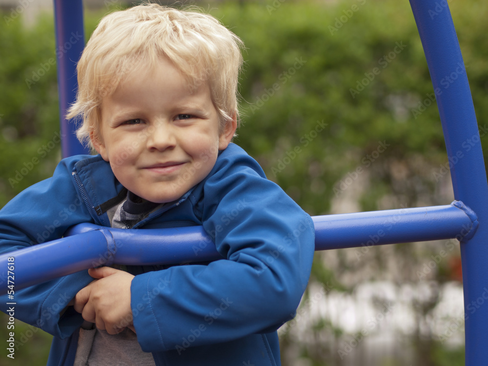 four year old boy at the playground smiling into camera four year old boy at the playground smiling into camera
