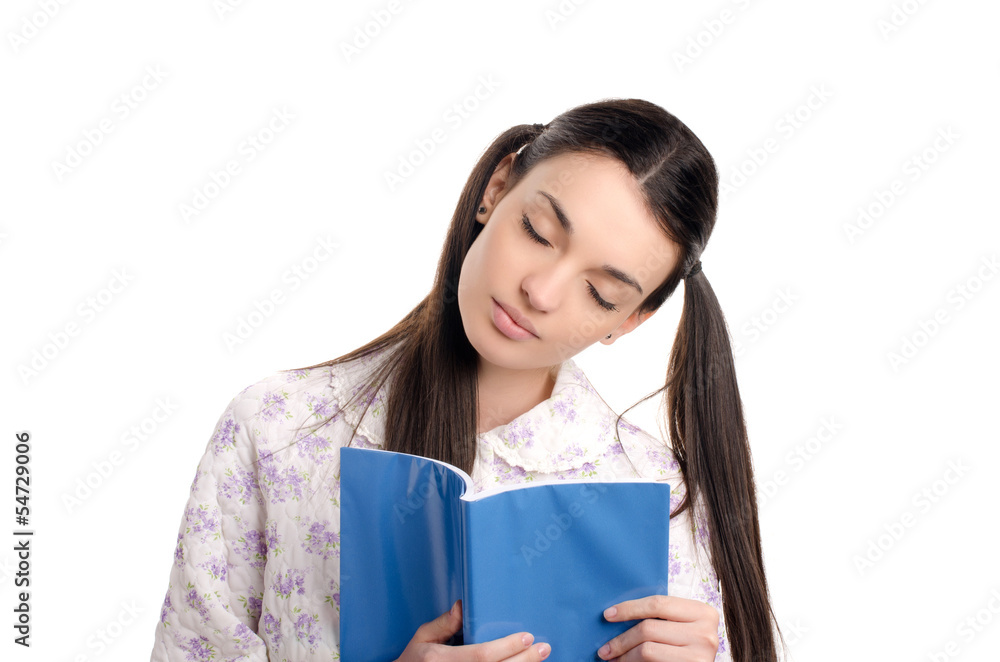 Tired girl in pajamas falling asleep with a book in her hands. Tired girl in pajamas falling asleep with a book in her hands.