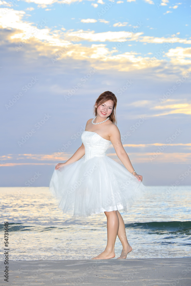 asian woman bride in her wedding dress in sunshine on a beautifu