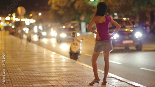 prostitute waiting for costumer on street at night photo
