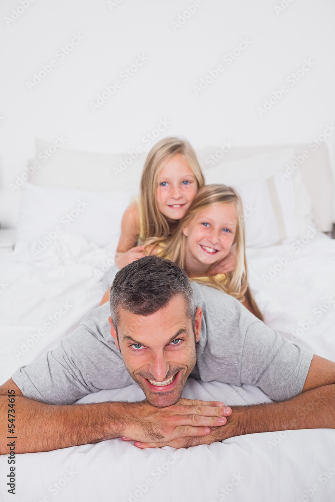 Man giving a piggy back to his children Man giving a piggy back to his children