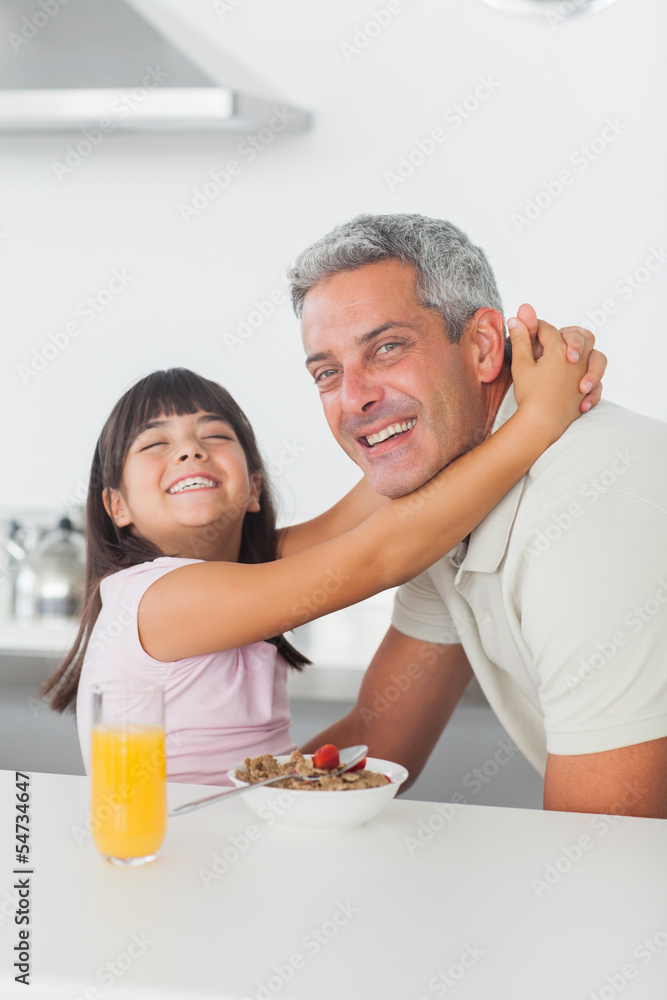 Smiling little girl hugging her dad