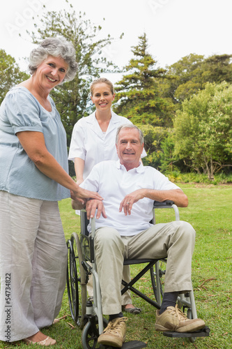 Man in wheelchair and his wife and nurse © WavebreakmediaMicro