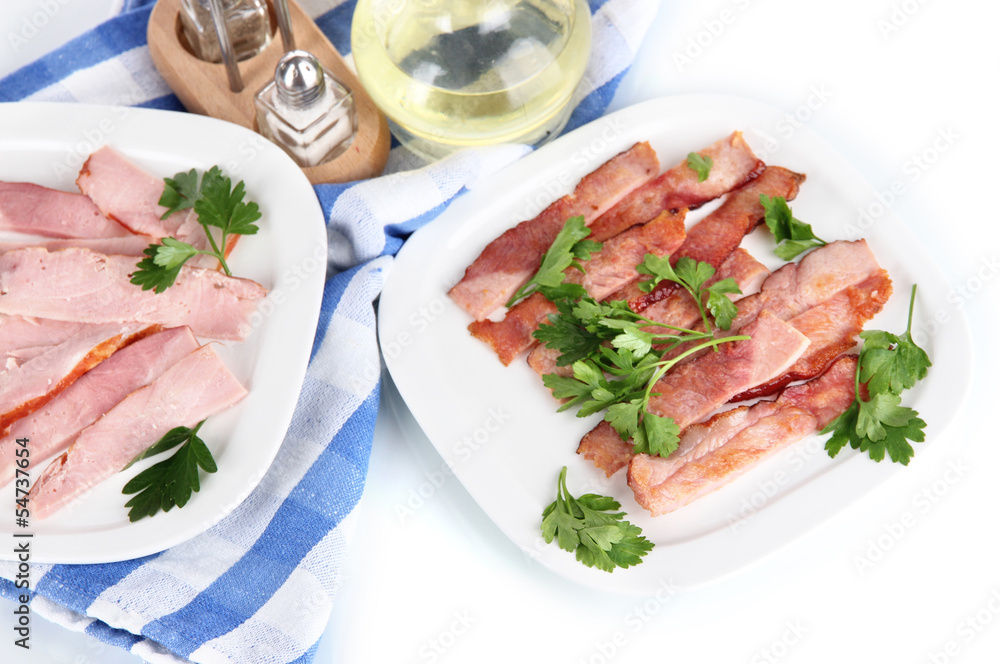 Bacon on plates on napkin isolated on white Bacon on plates on napkin isolated on white