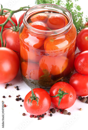 Open glass jar of tasty canned tomatoes, isolated on white