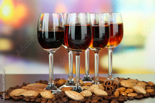 Glasses of liquors with almonds and coffee grains,