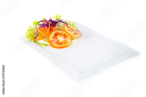 Plate and salad on top plate on white background