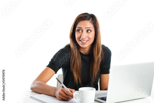 Attractive young Asian Indian teenage woman studying with laptop