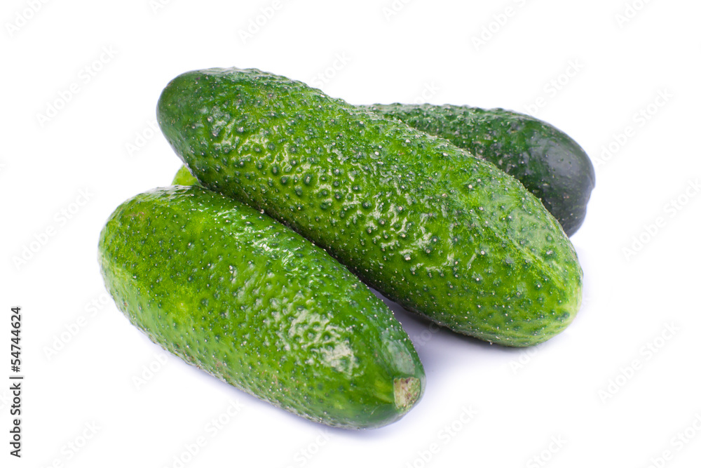 Healthy food. The green cucumbers isolated on white background Healthy food. The green cucumbers isolated on white background