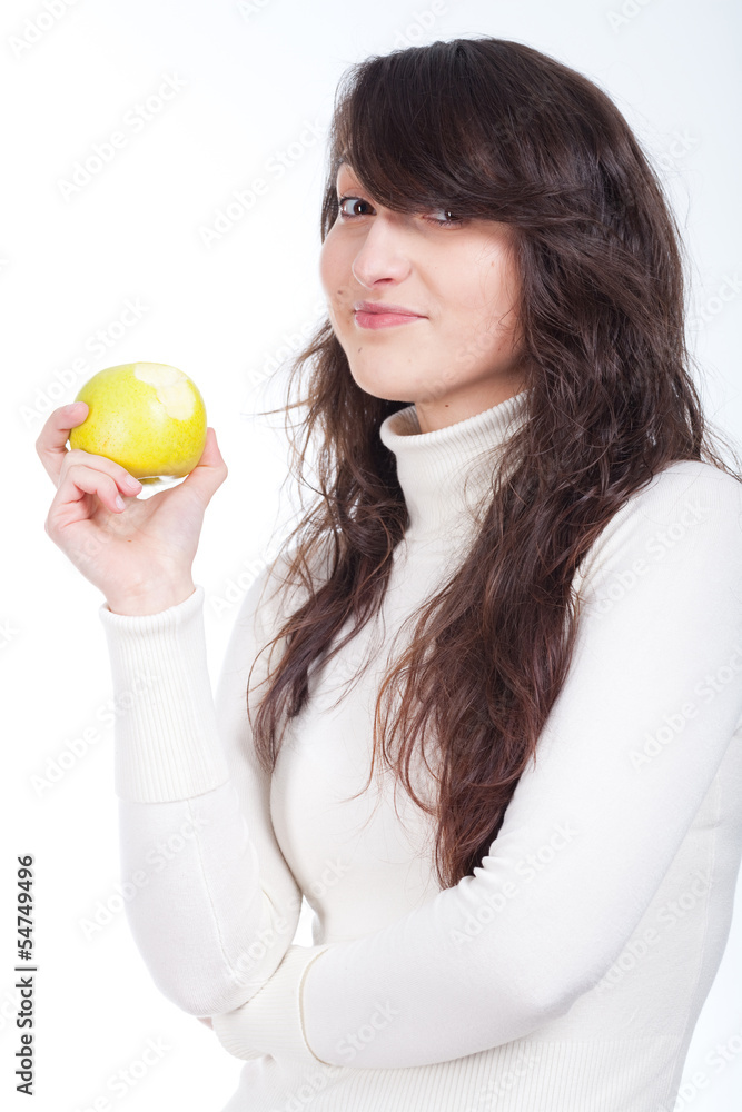 Young beautiful woman smiling with a green apple on hands Young beautiful woman smiling with a green apple on hands