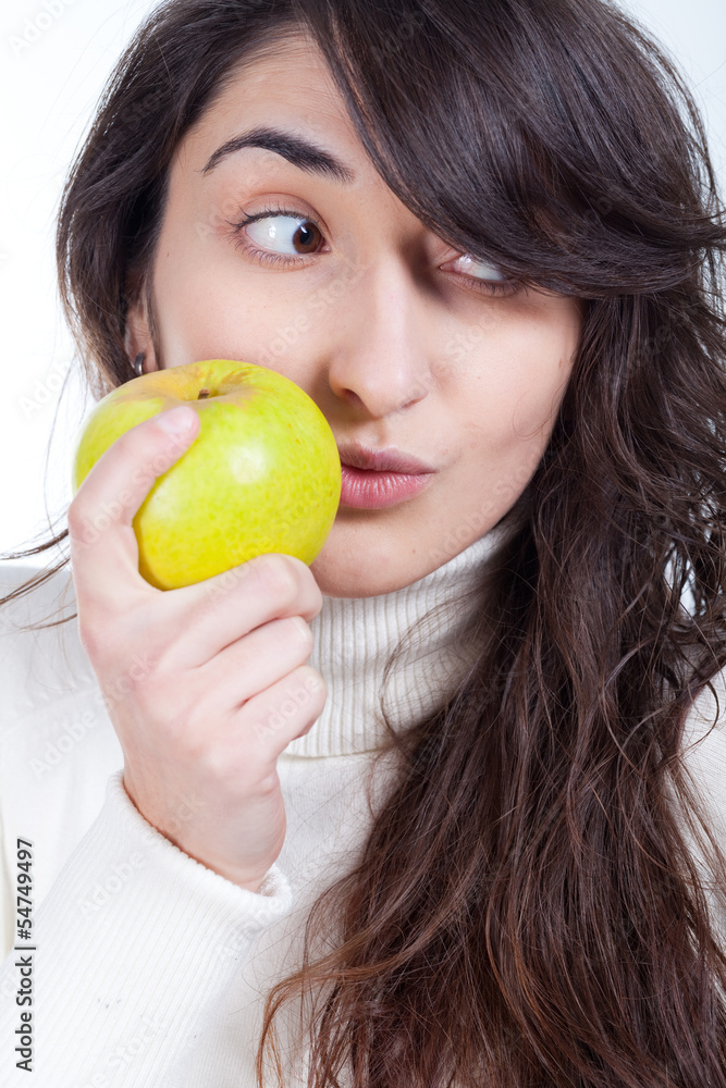 Young beautiful woman smiling with a green apple on hand Young beautiful woman smiling with a green apple on hand