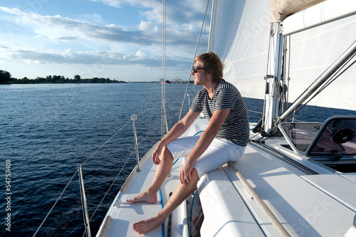 Happy young man on a yacht © Alex Shadrin