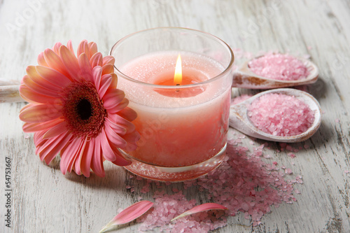 Beautiful spa setting with pink candle and flower