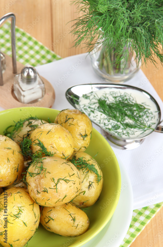 Boiled potatoes on platens on on napkins on wooden table Boiled potatoes on platens on on napkins on wooden table