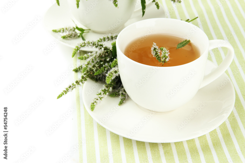 Cup of herbal tea with fresh mint flowers isolated on white Cup of herbal tea with fresh mint flowers isolated on white