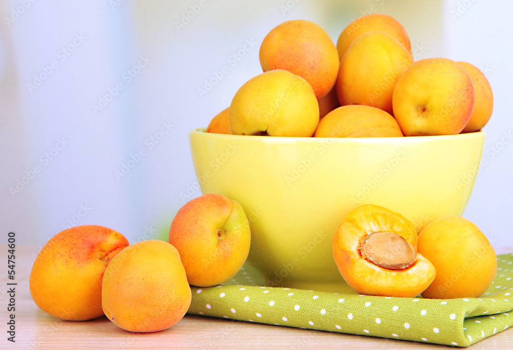 Fresh natural apricot in bowl on table in kitchen Fresh natural apricot in bowl on table in kitchen