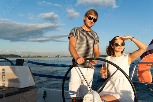 Happy young couple relaxing on a yacht © Alex Shadrin